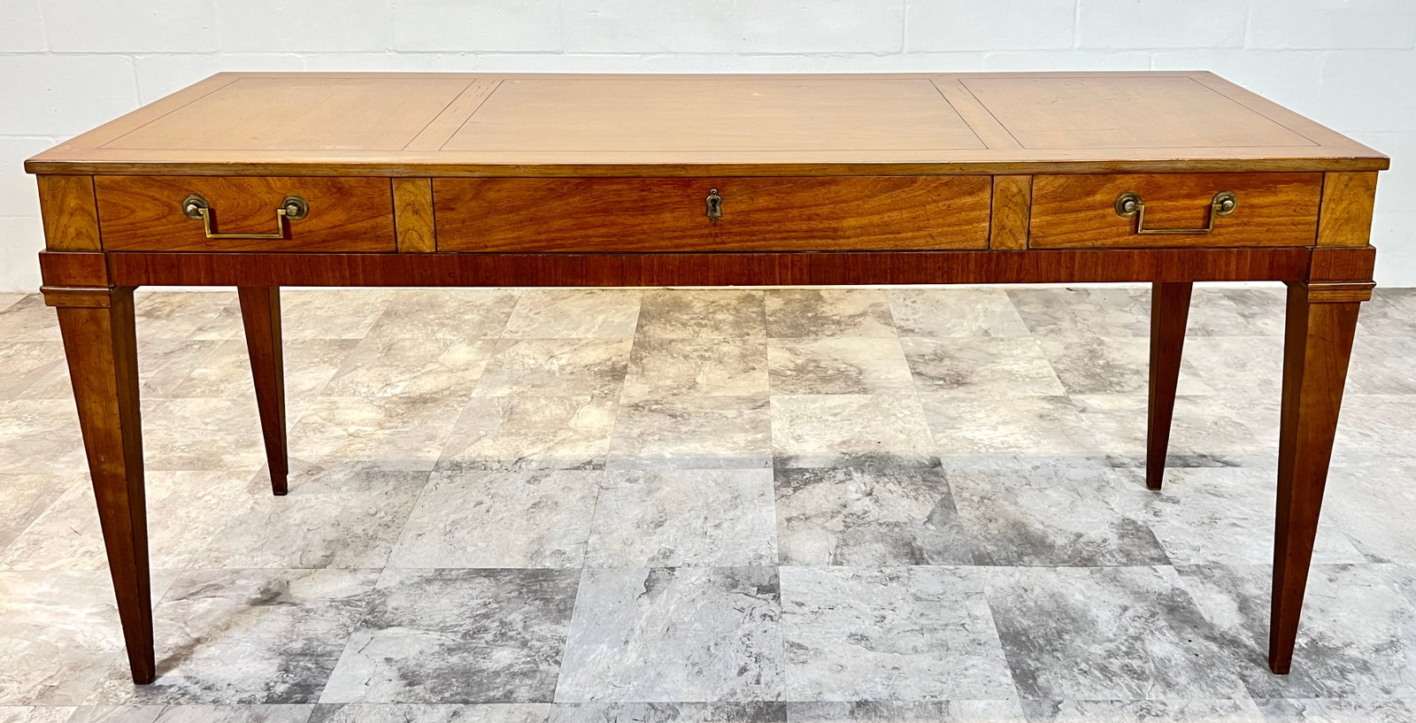 BAKER FURNITURE CONSOLE DESK: USE AS CONSOLE OR WRITING DESK, HAVING THREE DRAWERS, LABELED, WITH KEY. MINOR WEAR CONSISTENT WITH AGE AND GENTLE USE. 62"W, 22"D, 28"H