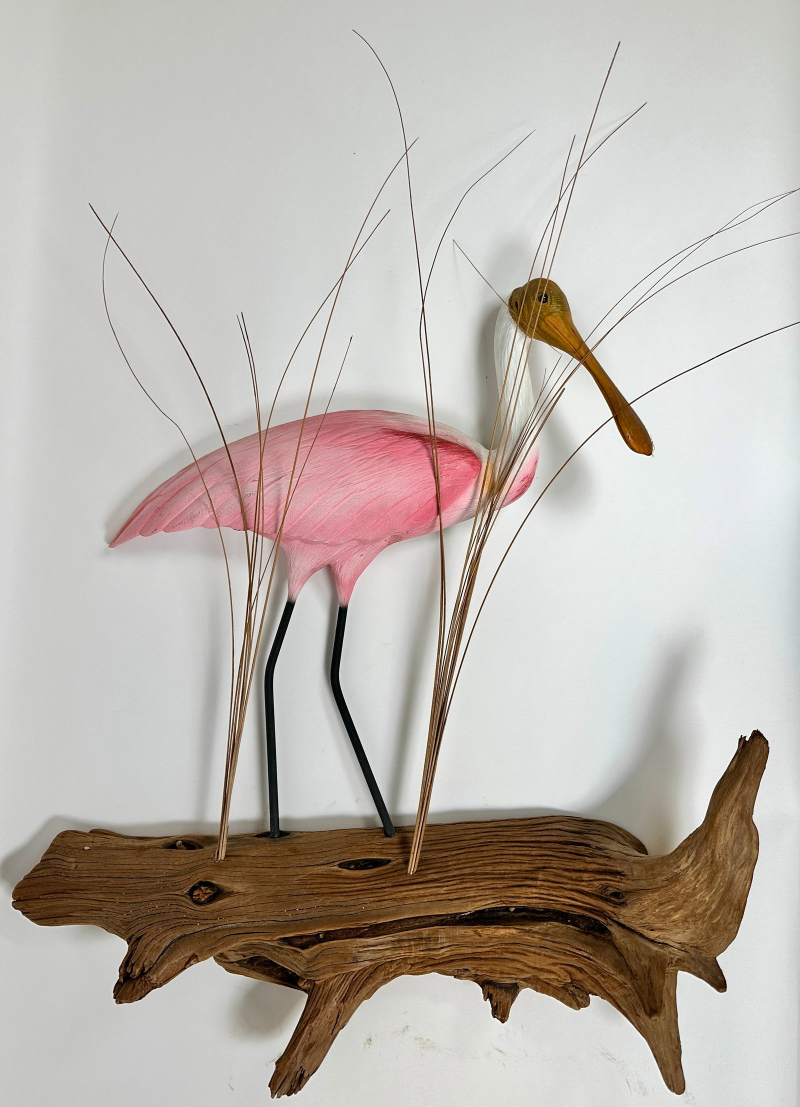 ROD BECKLUND BIRD SCULPTURE: RESIN DECORATED BIRD ON DRIFTWOOD BASE. 32"H OVERALL