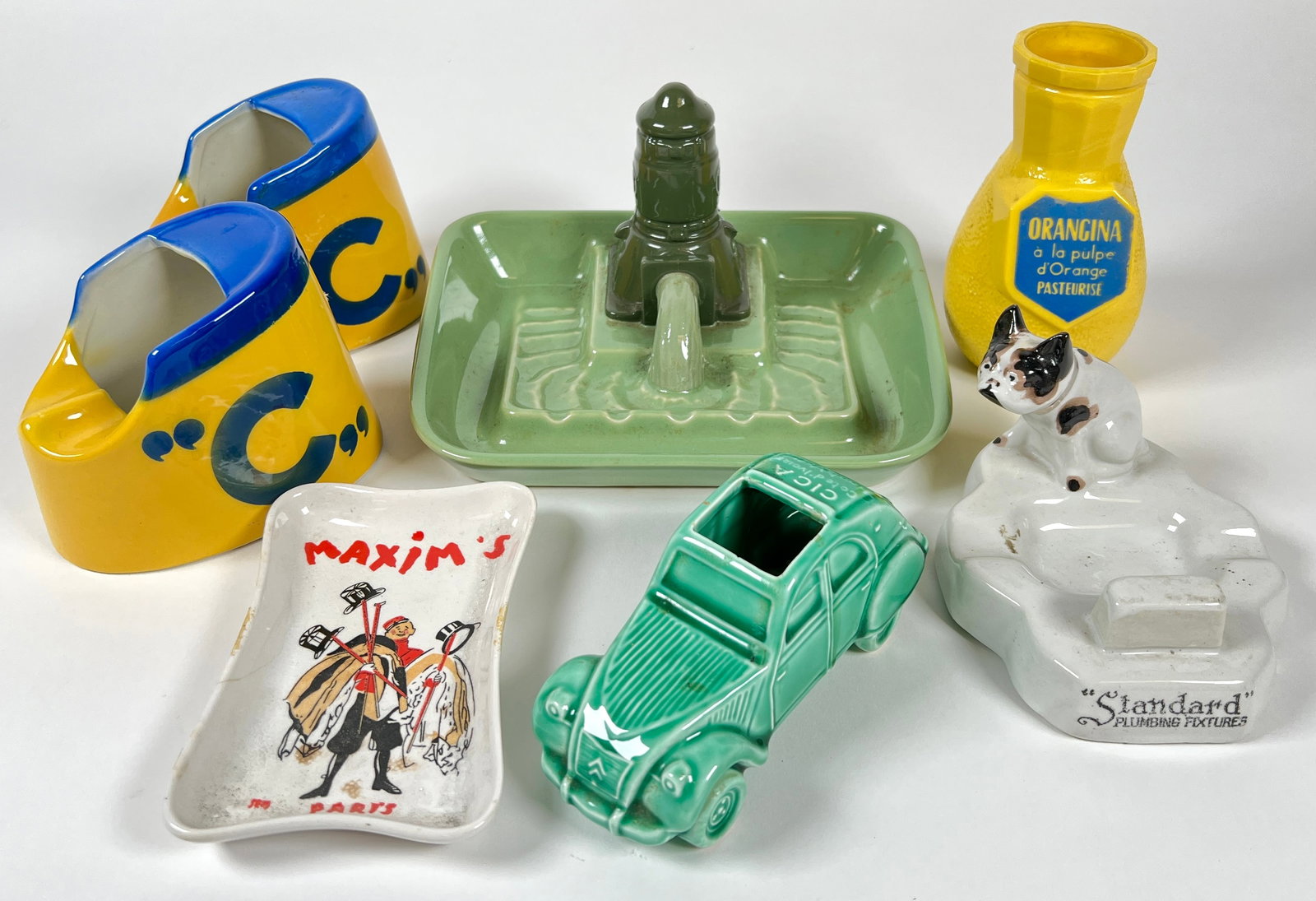 GROUPING OF ASHTRAYS: U.S. WESTERN HUECKEL CHINA, LINEA GENOVA, STANDARD PLUMBING FIXTURES, CICA COTE D'LIVOIRE HAUTE VOLTA PROCERAM, MAXIM'S.