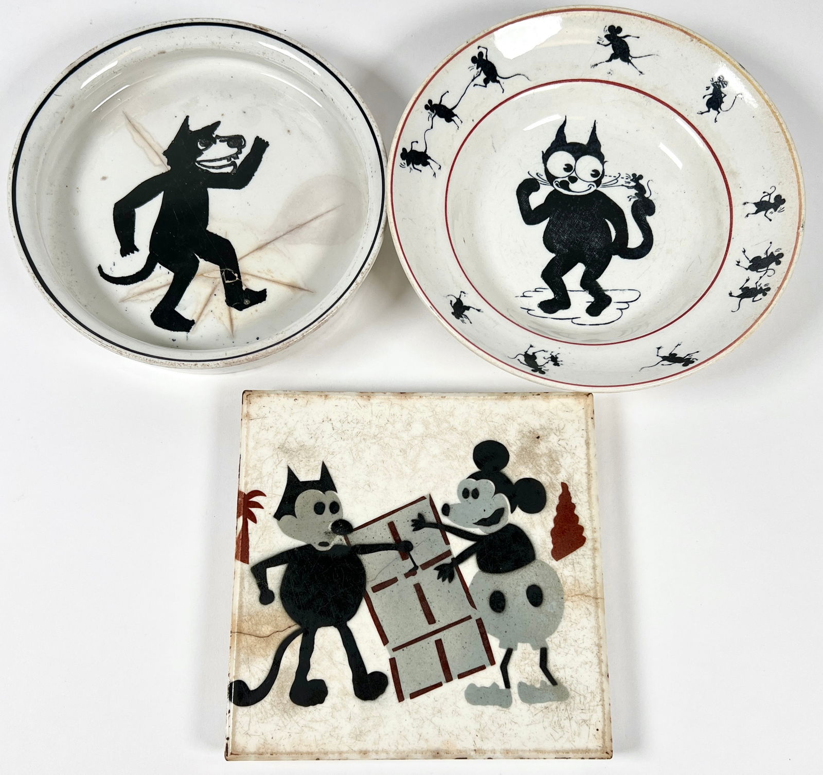 CHARACTER PORCELAINS: MICKEY MOUSE CERAMIC TILE 6", SCOTTISH FELIX BOWL 7". THIRD UNMARKED BOWL WITH REPAIR AS SHOWN. 6"