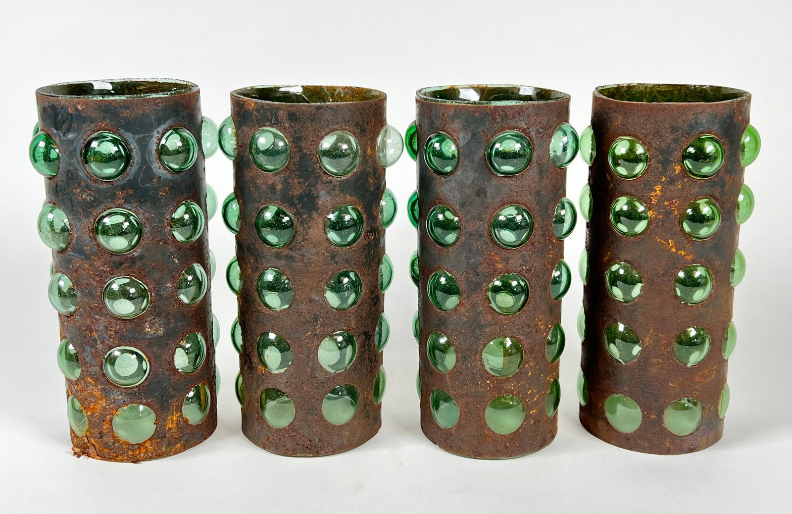 VIDRIO REAL JUAREZ CANDLE CHIMNEYS: GREEN BUTTON GLASS ENCASED IN PUNCHED METAL TOWER HOUSING. LABELED. 9"H