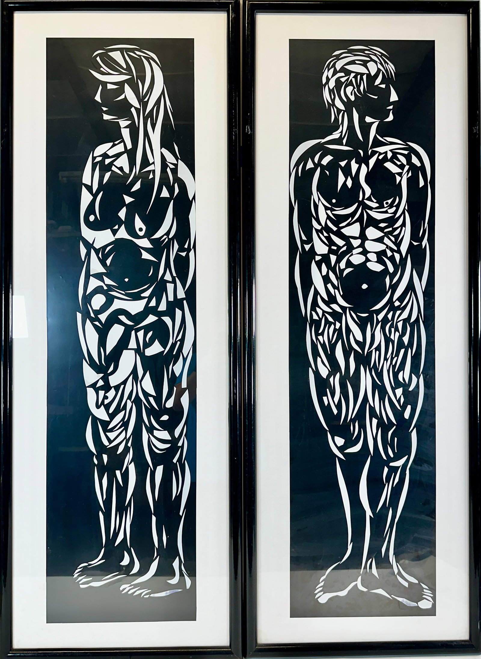 CONTRASTO CARVED ARTWORK: CONTRASTO HAND-CARVED WHITE VINLY OVER BLACK POLYESTER BY NATHAN POLSKY (AMERICAN, CONTEMPORARY). PAIR NUDE MALE AND FEMALE. FRAMED, 20"X56".