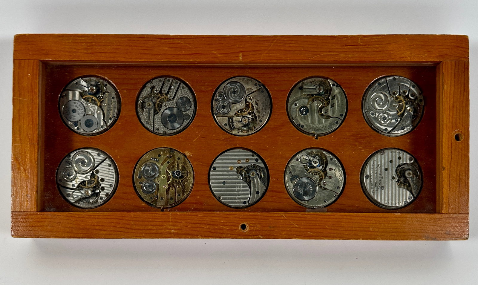 COLLECTION OF POCKETWATCH MOVEMENTS: IN WOODEN CASE. SETH THOMAS, ELGIN, POOLE, AND OTHERS.