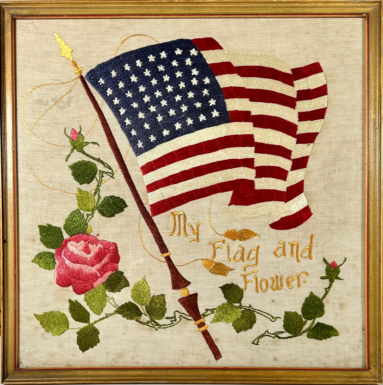 AMERICANA HAND-STITCHED FABRIC: HAND-STITCHED UNITED STATES FLAG AND FLOWER. FRAMED, 19"X19"