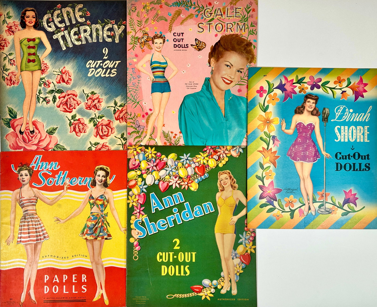 PAPER DOLL BOOK COLLECTION: LOT OF 5. SAALFIELD - WHITMAN, 1940'S. ANN SHERIDAN, DINA SHORE, ANN SOUTHERN, GALE STORM, GENE TIERNEY. UNCUT. SUE NAVE COLLECTION.