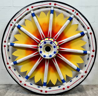 LARGE CIRCUS WAGON WHEEL: LARGE WAGON WHEEL WITH RETRO-FIT SUNBURST. IRON BAND TREAD AND PAINTED DECORATED SPOKES. 41" DIAMETER.