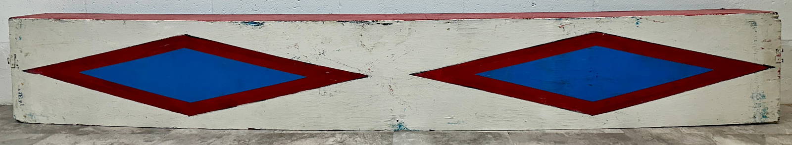 CIRCUS RING CURB: AUTHENTIC CIRCUS RING CURB AS WOULD HAVE DEFINED ONE OF THE PERFORMANCE AREAS. WOODEN CONSTRUCTION WITH RED, WHITE AND BLUE MOTIF PAINT. 84"L X 12"H