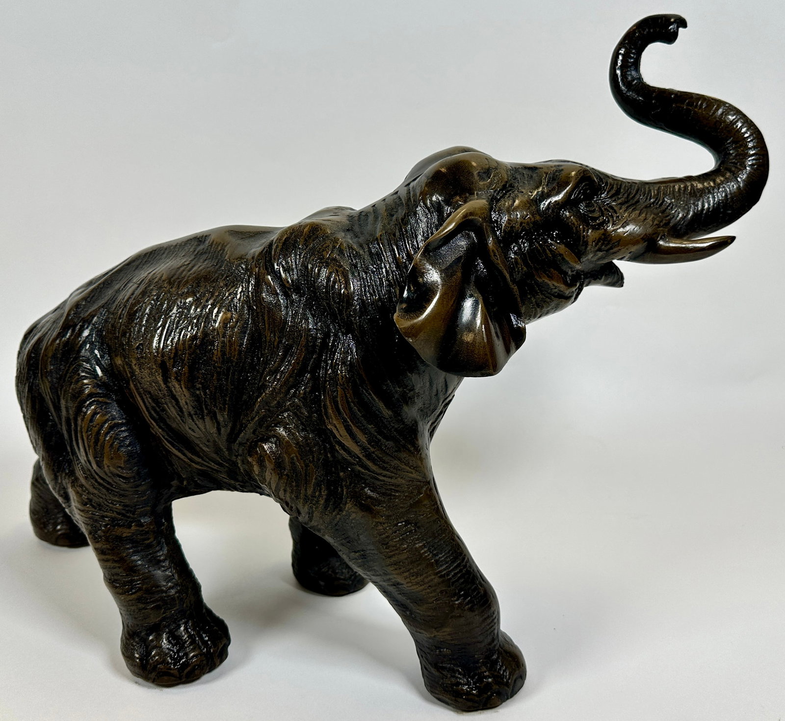 FIGURAL BRONZE ELEPHANT: BRONZE CLAD TRUPETING ELEPHANT SCULPTURE. 14"H, 20"L