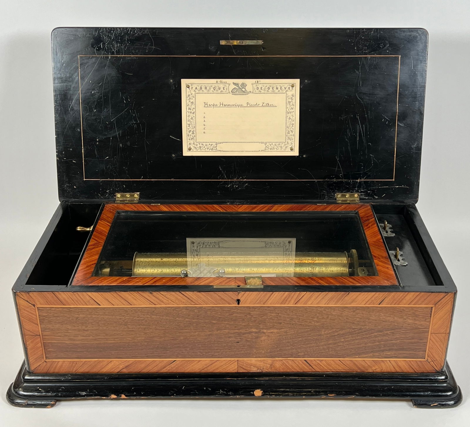 SWISS MUSIC BOX: ORIGINAL VINTAGE CONDITION, INLAID CASE DESIGNS, LID FITTED WITH BLANK SONG LIST. PLAYS AS IT SHOULD. STOP FEATURE NOT WORKING. 24"X12"X8"