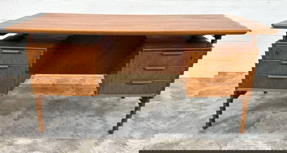 GUNNI OMANN MODEL 75 DESK: TEAK, FLOATING TOP WITH FRONT SIDE BOOKCASE. HAVING AREAS OF VERY MINOR WEAR. 60"W, 31.5"D, 29"H