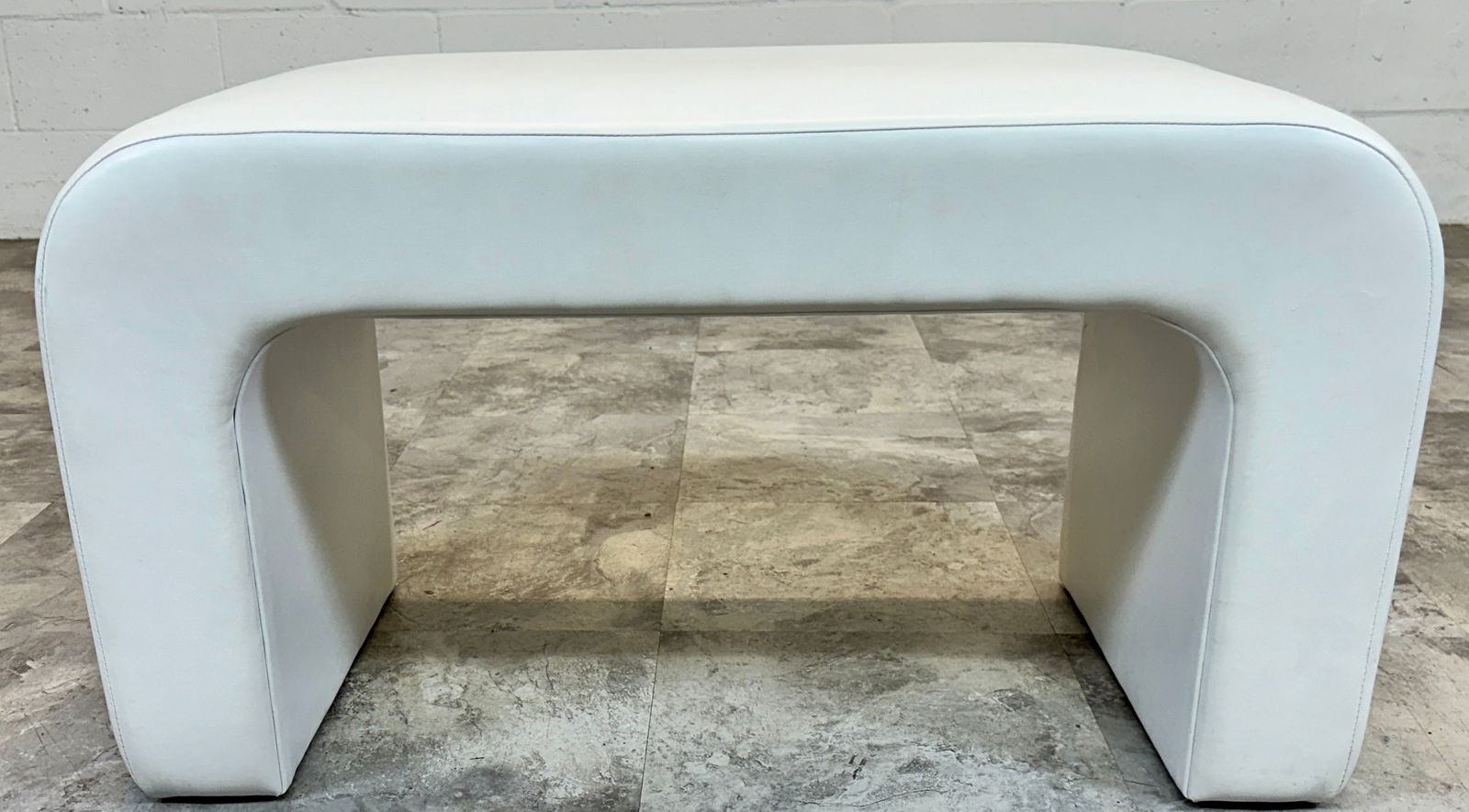 MODERN ARCHED STOOL: WHITE VINYL. 30"W, 15"D, 16"H