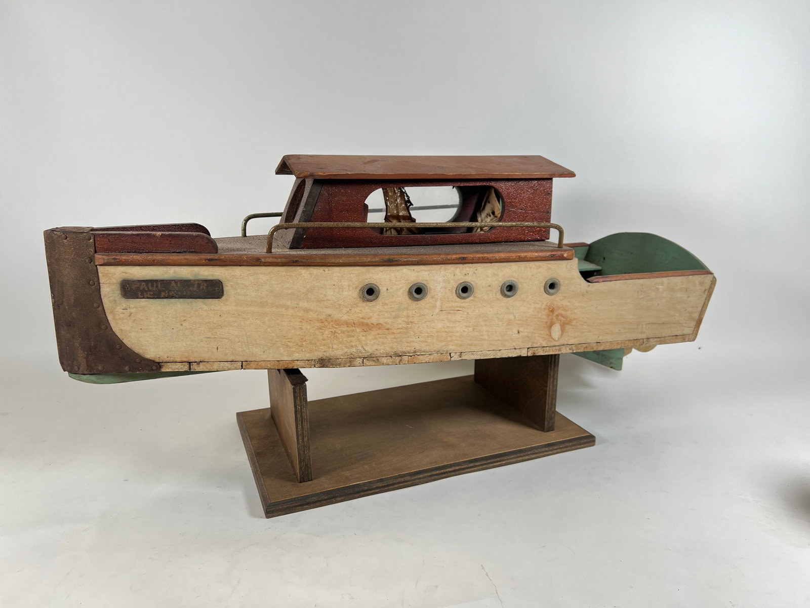 PRIMITIVE MODEL OF A YACHT: HAND-SCULPTED MODEL OF A YACHT COMPLETE WITH PORTHOLES AND RUDDER. MIXED MEDIA, PRIMARILY WOODEN CONSTRUCTION. ON STAND. 38"
