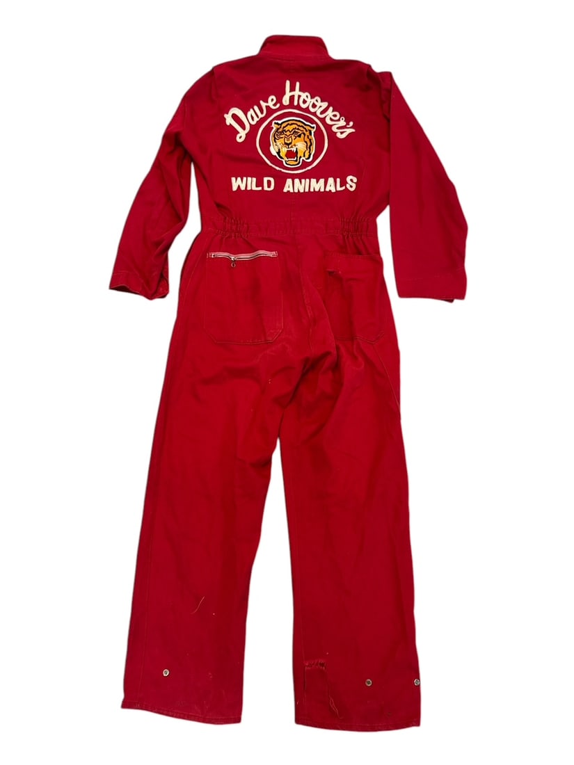 DAVE HOOVER WILD ANIMALS JUMPSUIT: RED JUMPSUIT WITH EMBROIDERED LOGO ON BACK, SIZE 38R. DAVE HOOVER (AMERICAN, 1930-2006) WAS A WILD ANIMAL TRAINER AND PROT?G? OF CLYDE BEATTY. HOOVER PERFORMED WITH MANY SHOWS INCLUDING CLYDE BEATTY-C