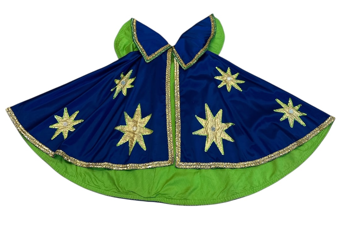 CIRCUS SPEC CAPE WARDROBE: GOLD STARS WITH CENTRAL MIRROR ACCENT ON A FIELD OF BLUE WITH GREEN TRIM AND LINER.