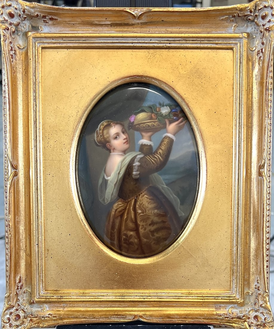 ANTIQUE PORCELAIN HAND-PAINTED PLAQUE: AFTER TITIAN GIRL WITH A PLATTER OF FRUIT, PORCELAIN CONTINENTAL HAND-PAINTED PLAQUE IN GILT FRAME. MARKED. NEWCOMB MACKLIN FRAME. HAS NOT BEEN EXAMINED OUTSIDE OF FRAME. SIGHT 5"X7", 10"X12".