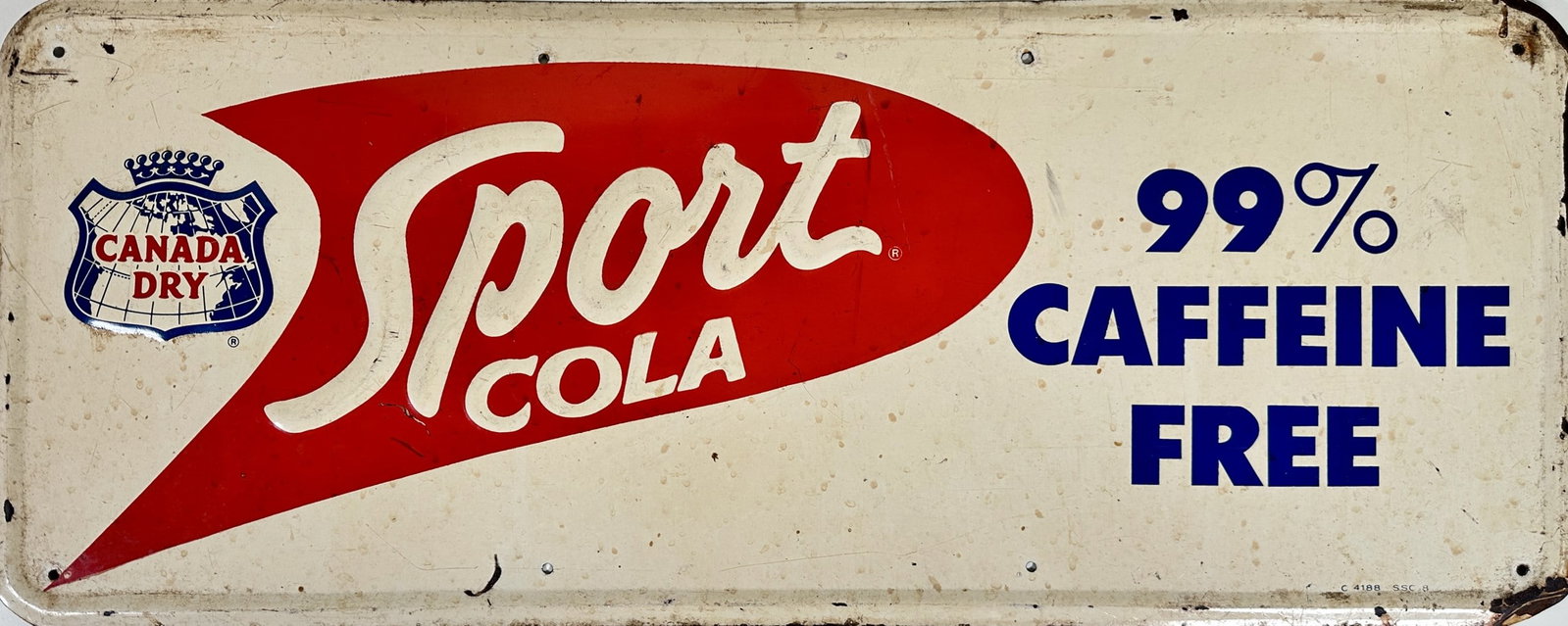 SPORT COLA - CANADA DRY SST ADVERTISING SIGN: SPORT COLA - CANADA DRY. 99% CAFFEINE FREE. SINGLE SIDED EMBOSSED TIN SIGN. EDGE PITTING, STAINING. 12"X30"