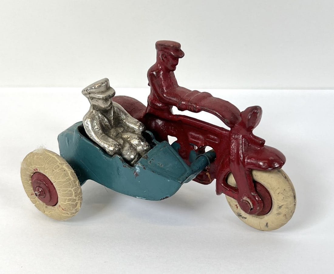 HUBLEY LINDY CAST IRON TOY AIRPLANE: RED WITH NICKEL PLATED WHEELS, ENGINE AND PROP. ORIGINAL PAINT WITH SCATTERED LOSS, ELSE GOOD. 4.25"L