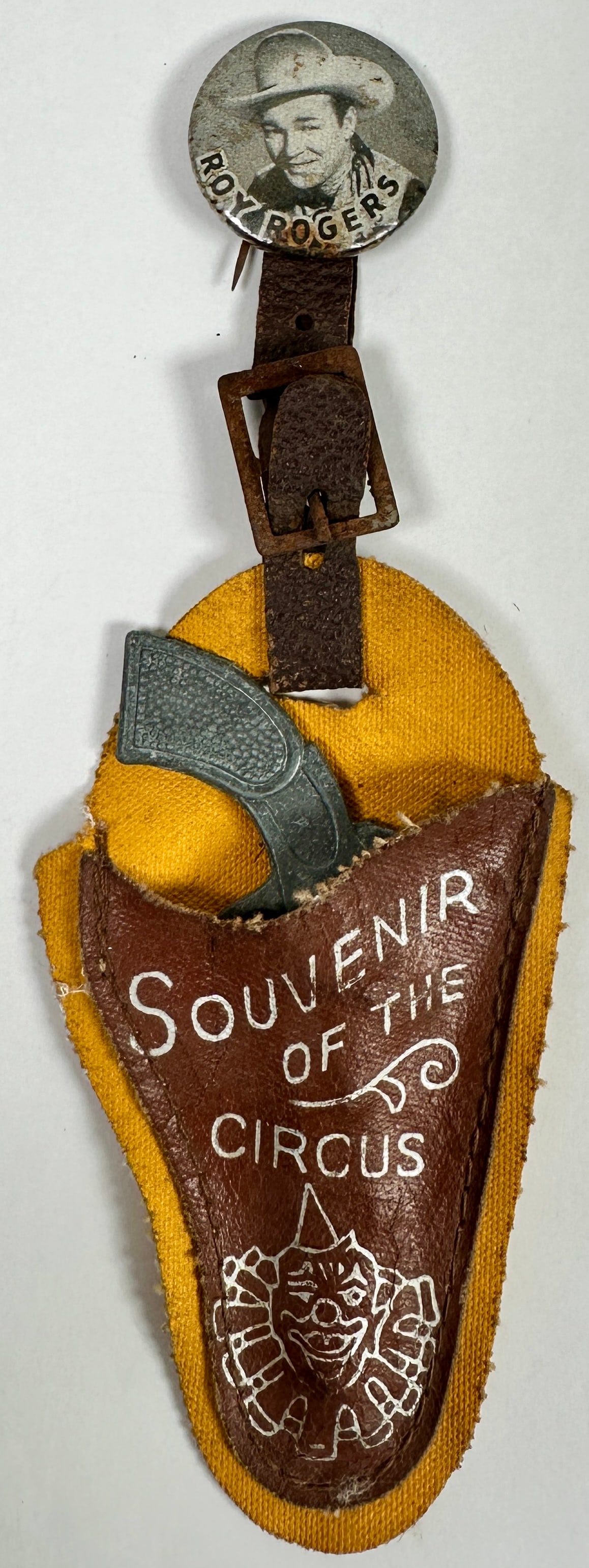 Roy Rogers - Souvenir of the Circus: Juvenile souvenir of the circus, Roy Rogers pin-back button and toy revolver. Leather is brittle, areas of corrosion on button, else good.