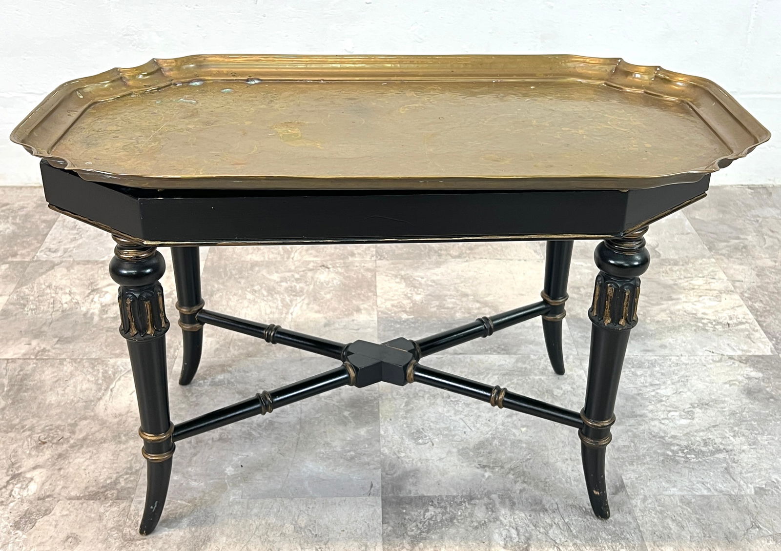 LA MAISON SUPREME TABLE: EBONIZED WOODEN FRAME WITH GILT DECORATIONS, REMOVEABLE BRASS TRAY. 30"X17"X19". REQUIRES THIRD PARTY SHIPPING/TRANSPORTATION.