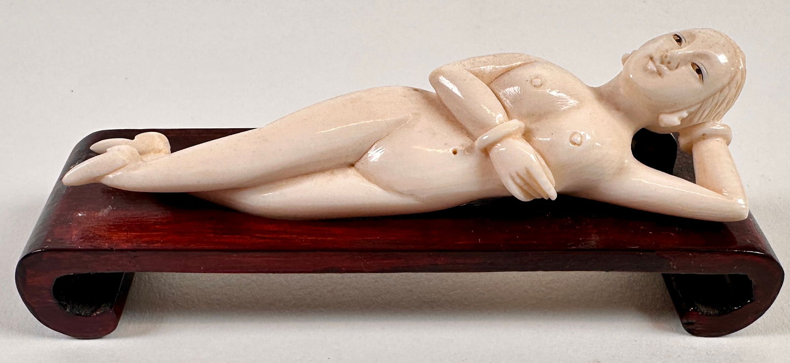 ORGANIC CARVING - DOCTOR'S DOLL: RECLINING NUDE OR DOCTOR'S DOLL ON WOODEN STAND. 4.5"L