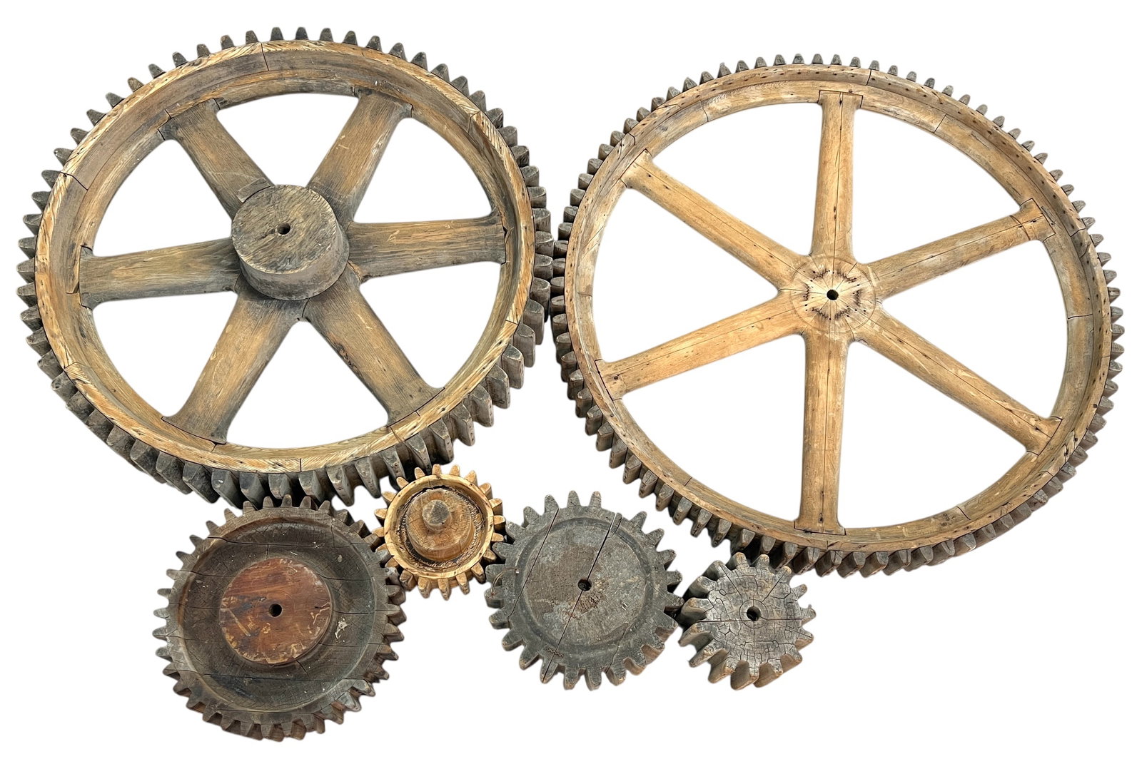 INDUSTRIAL FRAGMENTS - GEAR DISPLAY: A COLLECTION OF WOODEN GEARS AS ART. LARGEST 33"DIA.