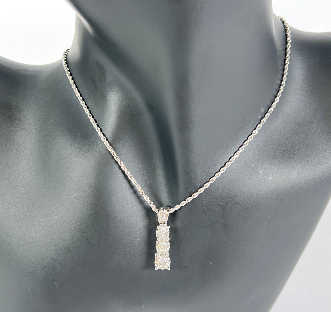14K GOLD WITH DIAMOND PENDANT NECKLACE: 14K WHITE GOLD WITH TRIO OF GRADUATED DIAMOND PENDANTS. 16" CHAIN. 7 GRAMS TOTAL WEIGHT.