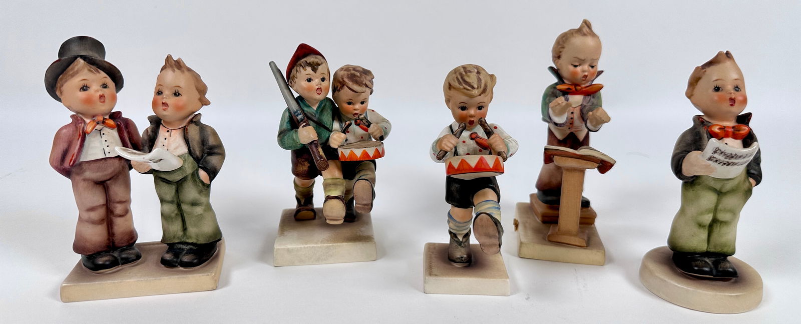GOEBEL HUMMEL FIGURINE COLLECTION: ESTATE COLLECTION OF GOEBEL HUMMELS. TWO GENERATIONS OF MARKS FROM 1960-1972. INCLUDES: SOLOIST, BAND LEADER, DUET, VOLUNTEERS, LITTLE DRUMMER. TALLEST 5"
