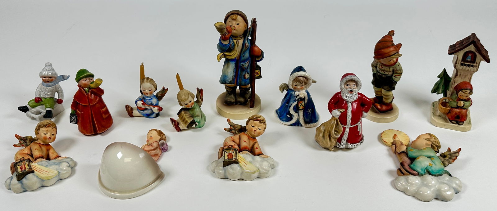 GOEBEL HUMMEL FIGURINE COLLECTION: ESTATE COLLECTION OF GOEBEL HUMMELS. THREE GENERATIONS OF MARKS 1960-1990. INCLUDES: HERE YE - HEAR YE, MARCH WINDS, ANGEL ON CLOUD WITH LANTERN, TWO WALL PLAQUES, MERRY CHRISTMAS, HOLY WATER, ANGEL C