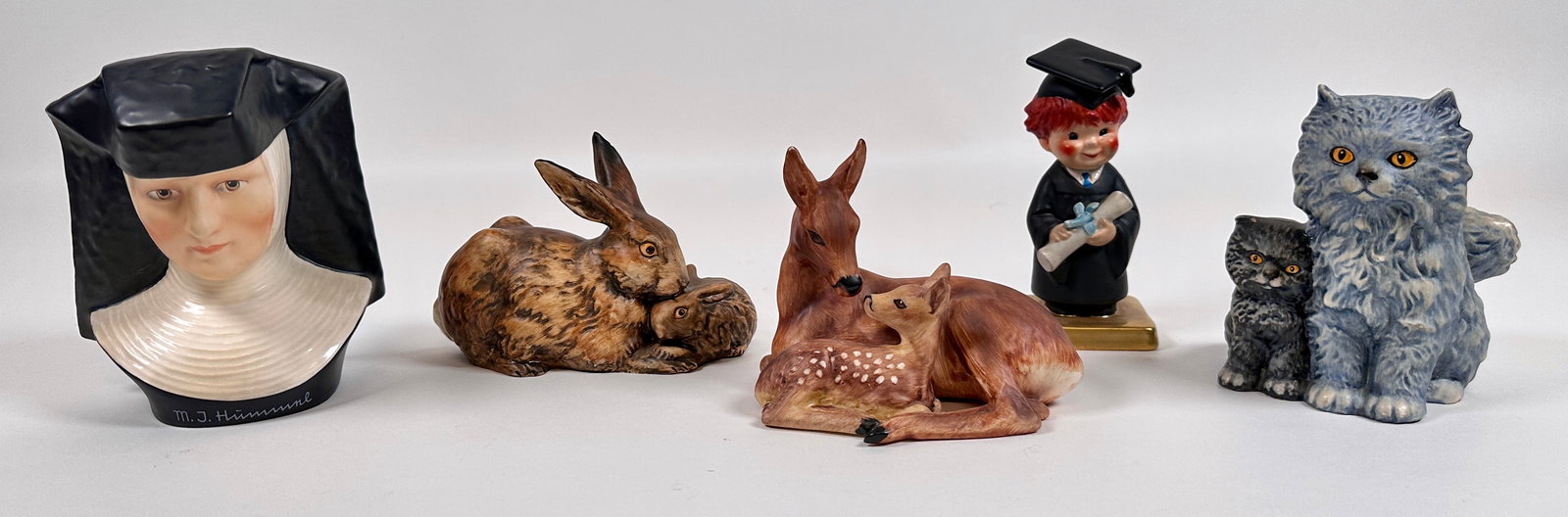 GOEBEL HUMMEL FIGURINE COLLECTION: ESTATE COLLECTION OF GOEBEL HUMMELS. MARKS 1972-79. NUN BUST, EASTER BUNNY, RABBIT WITH BABY, DEER AND FAWN, PERSIAN CAT AND KITTEN, BACHELOR DEGREE. TALLEST 5.5"