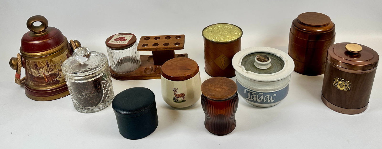TOBACCO TINS AND HUMIDORS: A VARIETY OF TOBACCO CONTAINTERS AND STAND INCLUDING CERAMIC, WOODEN, GLASS AND TINS.