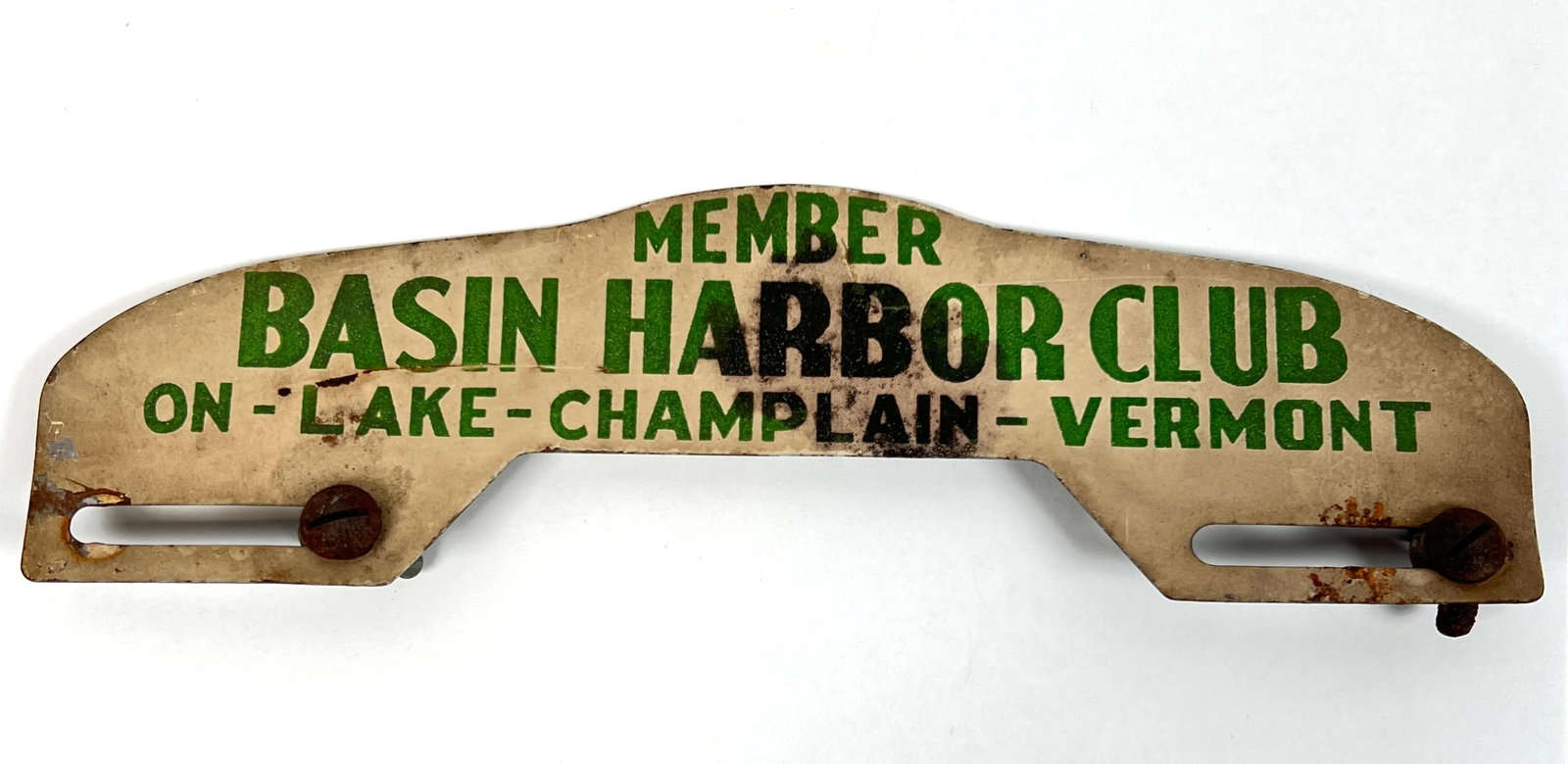 BASIN HARBOR CLUB AUTO TAG TOPPER: MEMBER BASIN HARBOR CLUB - ON LAKE CHAMPLAIN - VERMONT. METAL AUTO LICENSE PLATE TAG TOPPER. WITH AREAS OF WEAR TO FINISH AS SHOWN. 10"X4"