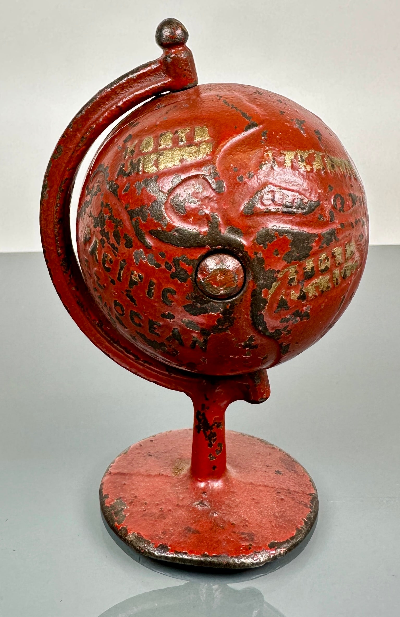 GREY IRON CASTING GLOBE COIN BANK: C.1900 CAST IRON COIN BANK, ORIGINAL WITH PAINT LOSS COMMENSURATE WITH AGE. 5"H