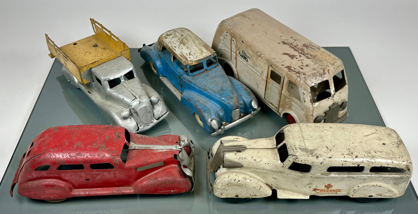 COLLECTION OF VINTAGE PRESSED STEEL TOY TRUCKS: ALL ORIGINAL WITH PAINT LOSS AND PLAY WEAR COMMENSURATE WITH AGE. AVERAGE 11"X4"X4"