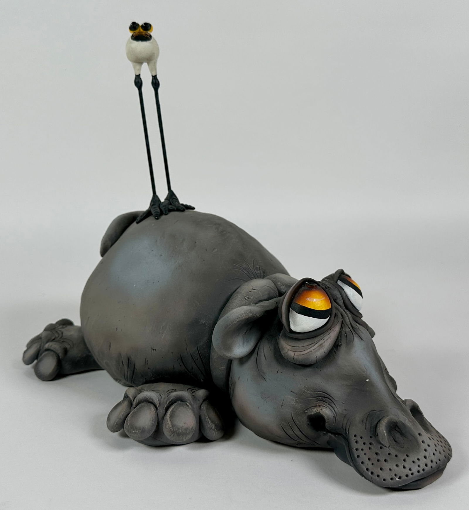 TODD WARNER HIPPO SCULPTURE: TODD WARNER (AMERICAN, 1945-2022) CERAMIC HIPPO AND BIRD, FROM THE BABY'S FIRST STEPS SERIES. SIGNED. EDITION 19/250. 11"X9"X12"