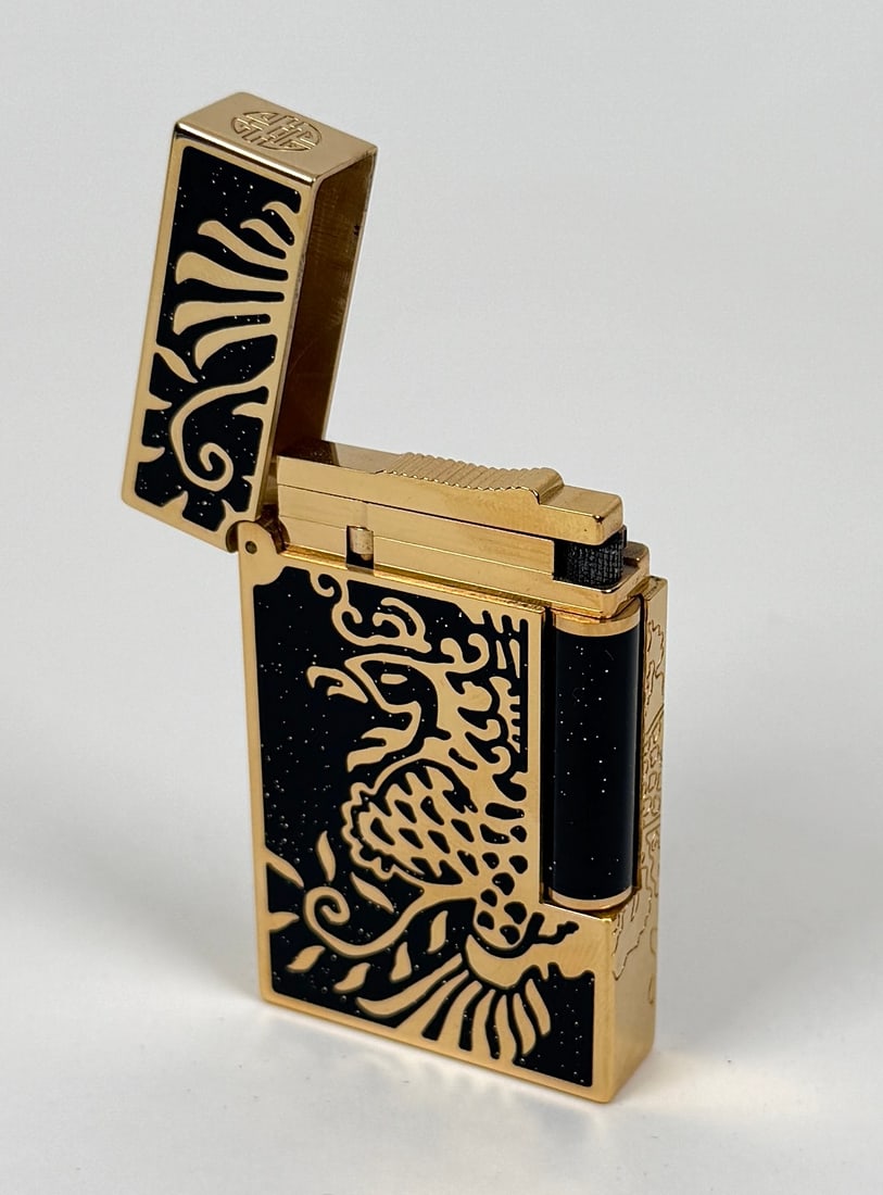 S.T. DUPONT LIGNE 2 PHOENIX LIGHTER: 18K OVERLAY GOLD OVER BLACK LACQUER FINISH, S.T. DUPONT - PARIS. LIMITED EDITION 681/888. GOLD-TONED WITH PHOENIX DESIGNS. ORIGINAL CASE AND OUTER CARTON. AS NEW CONDITION. OUTER CARTON WITH HANDLING