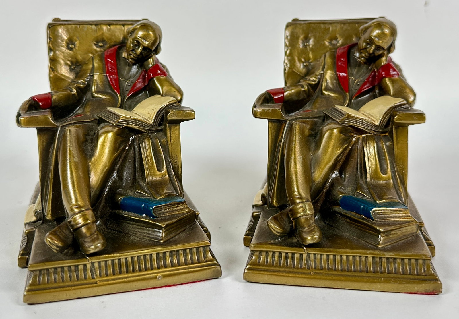 KRONHEIM & OLDENBUSCH - SLEEPING SCHOLAR: PAIR OF BOOKENDS BY K&O, MARKED. BRONZED PLATED, PAINTED DETAILS, C.1930'S.