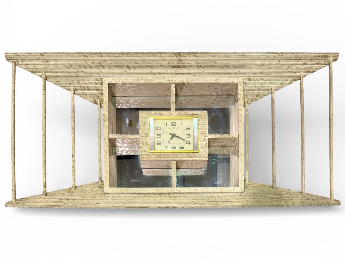 GE MID-CENTURY MODERN WALL CLOCK WHAT-NOT SHELF: GENERAL ELECTRIC CLOCK MOUNTED IN MID-CENTURY MODERN WHAT-NOT SHELF. MIRRORED SHADOW BOX. WOODEN CONSTRUCTION. CLOCK IS WORKING. GOOD VINTAGE CONDITION. SMALL FRACTURE IN CLOCK FACE COVER. 48"W, 22"H,