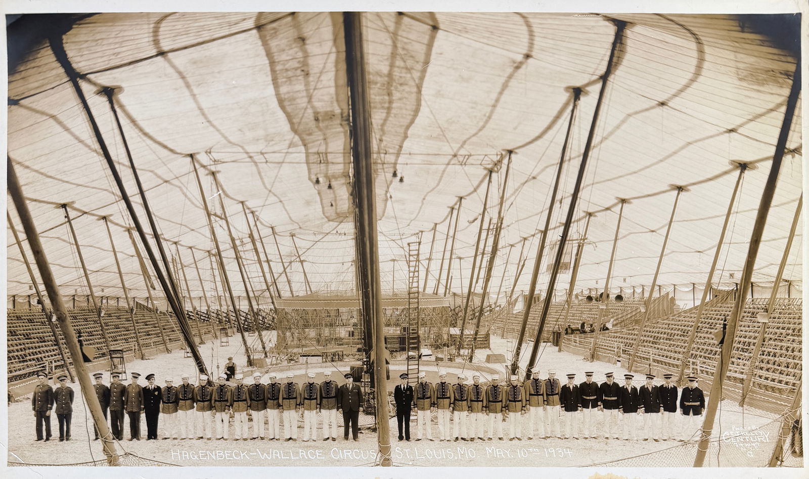 EDWARD J. KELTY CIRCUS PHOTOGRAPH - HW CIRCUS: EDWARD J. KELTY (AMERICAN, 1888-1967) PHOTOGRAPH OF THE HAGENBECK WALLACE CIRCUS, ST. LOUIS, MO., MAY 10, 1934. PANORAMIC PHOTOGRAPH OF A SPLENDID TENT INTERIOR SCENE, USHERS AND TICKET MEN STANDING