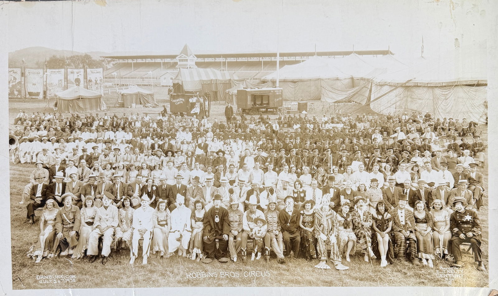 EDWARD J. KELTY CIRCUS PHOTOGRAPH - ROBBINS: EDWARD J. KELTY (AMERICAN, 1888-1967) PHOTOGRAPH OF THE ROBBINS BROS. CIRCUS, DANBURY, CONNECTICUT, JULY 26, 1938. PANORAMIC PHOTOGRAPH OF THE CAST AND CREW OF THE SHOW GATHEREED AMONG TENTS,