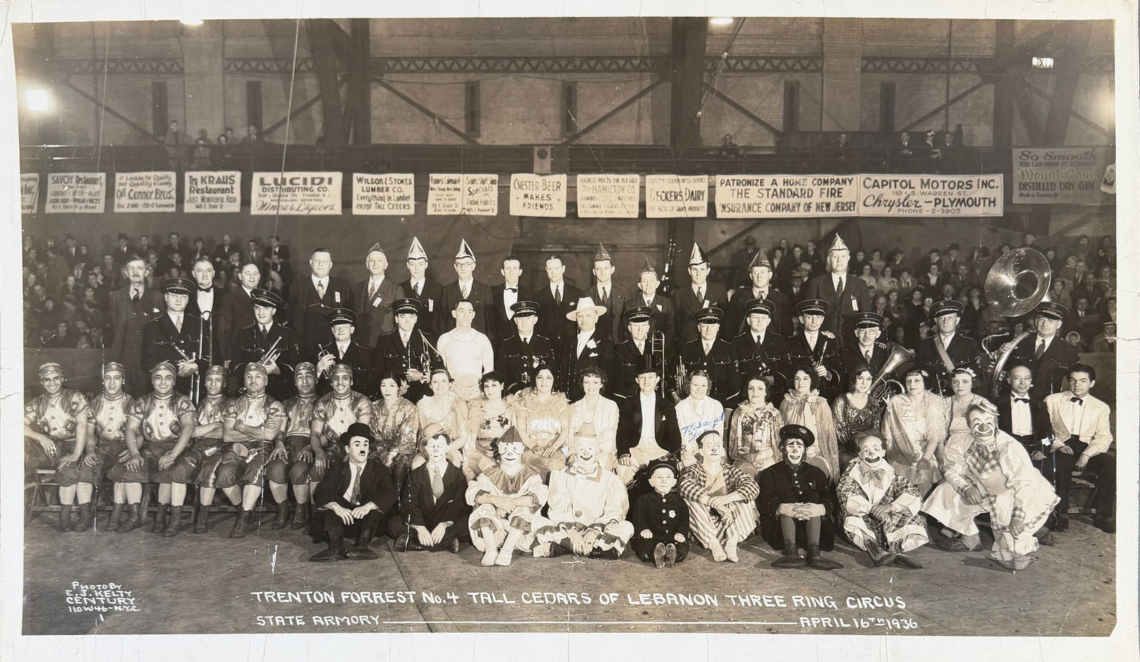 EDWARD J. KELTY CIRCUS PHOTOGRAPH: EDWARD J. KELTY (AMERICAN, 1888-1967) PHOTOGRAPH OF TRENTON FORREST NO. 4 TALL CEDARS OF LEBANON THREE RING CIRCUS, STATE ARMORY, APRIL 16, 1036. PANORAMIC PHOTOGRAPH OF PERFORMERS, BAND, OFFICERS. 