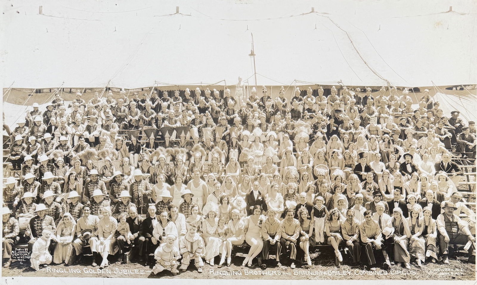 EDWARD J. KELTY CIRCUS PHOTOGRAPH - RBBB CIRCUS: EDWARD J. KELTY (AMERICAN, 1888-1967) PHOTOGRAPH OF THE RINGLING BROS. AND BARNUM & BAILEY CIRCUS GOLDEN JUBILEE, NEWARK, N.J., 1933. PANORAMIC PHOTOGRAPH OF THE CAST OF THE SHOW. MOUNTED ON BOARD.