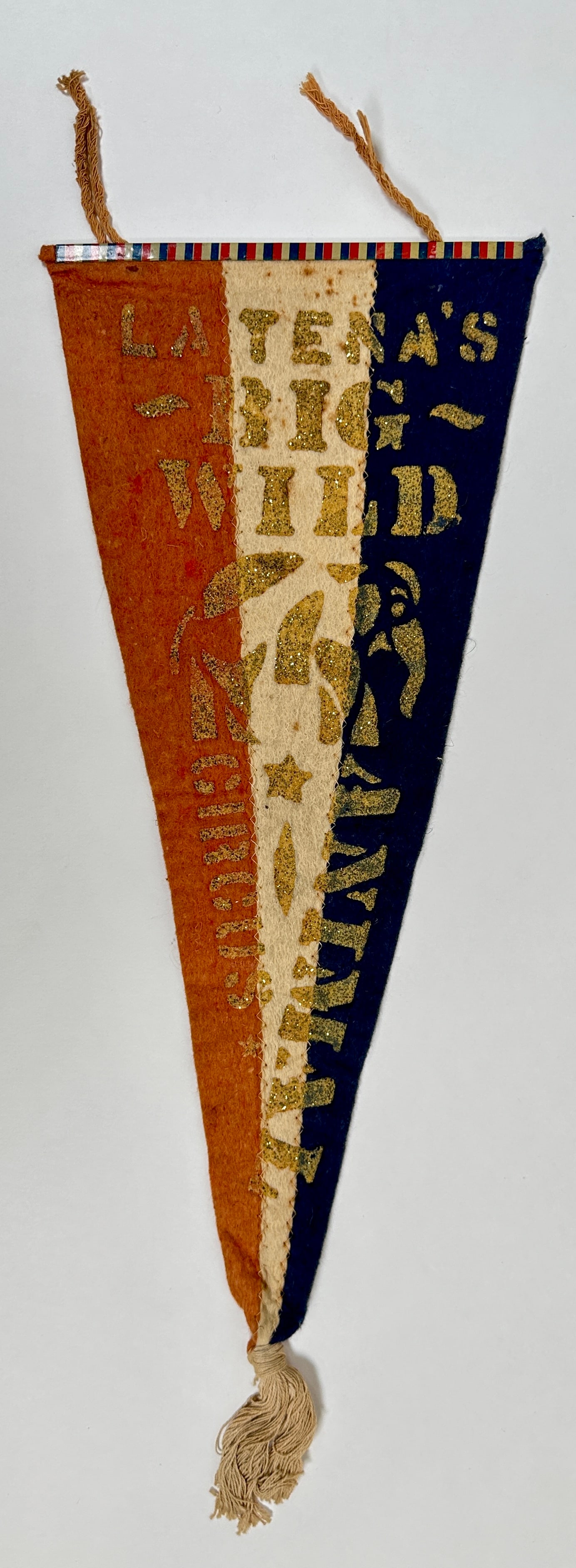 LA TENA'S BIG WILD ANIMAL CIRCUS SOUVENIR PENNANT: ORIGINAL SOUVENIR PENNANT FOR LA LENA'S SHOW, C.1914. FELT PENNANT WITH APPLIED, EMBOSSED GLITTER TEXT AND END TASSLE. 19"