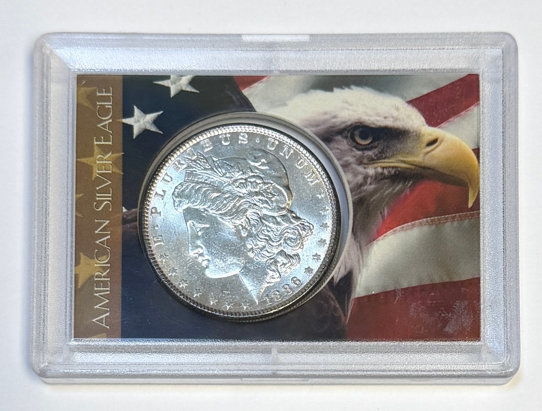 1886 MORGAN SILVER DOLLAR: UNCIRCULATED, IN A.S.E. HOLDER.
