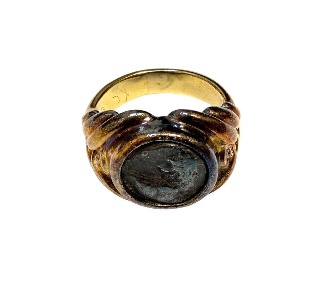 GENTLEMAN'S GOLD GREEK COIN RING: 18K GENT'S RING HAVING SET WITHIN AN AUTHENTIC ANCIENT GREEK COIN. PURCHASE FROM NORDSTROM'S FINE JEWELRY DEPARTMENT, PARAMUS, NEW JERSEY IN MARCH OF 1994. INCLUDES STATEMENT OF SALE, VALUATION FOR $1