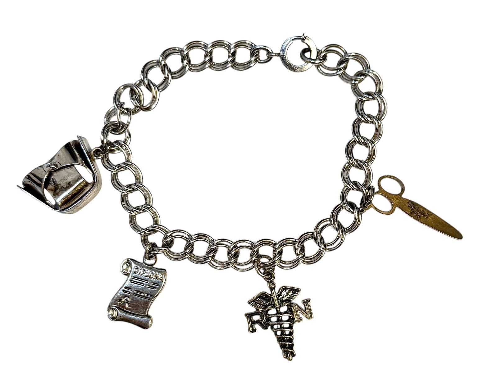 STERLING SILVER NURSE'S BRACELET: STERLING LINK BRACELET WITH FOUR CHARMS. MOST MARKED STERLING. 19 GRAMS IN TOTAL WEIGHT.