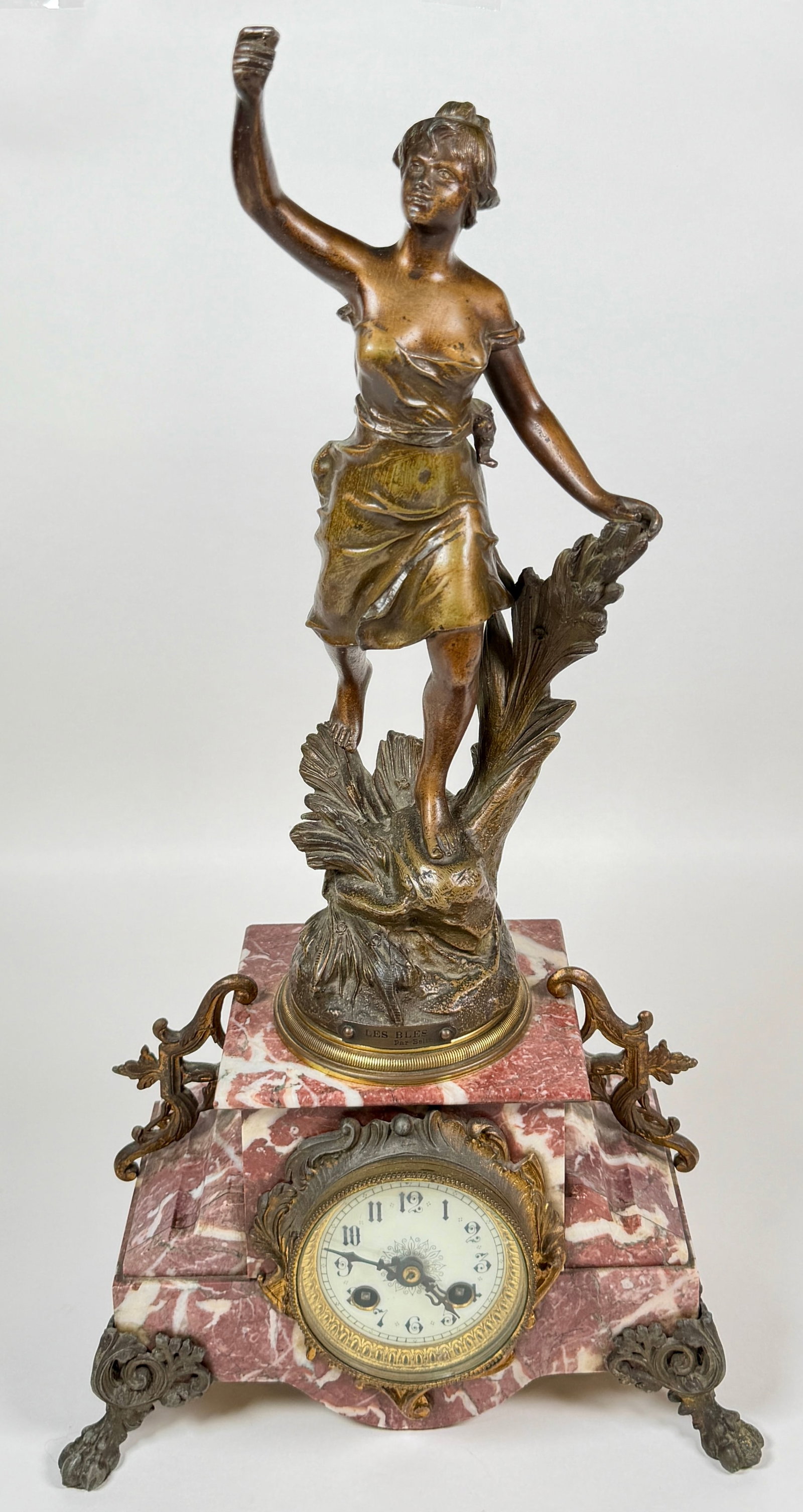 FRENCH FIGURAL MANTEL CLOCK: FIGURAL BRONZE LABELED LES BLES - PAR BELIN. ON MARBLE BASE. COMPLETE AND RUNNING AT TIME OF SALE. 23"H