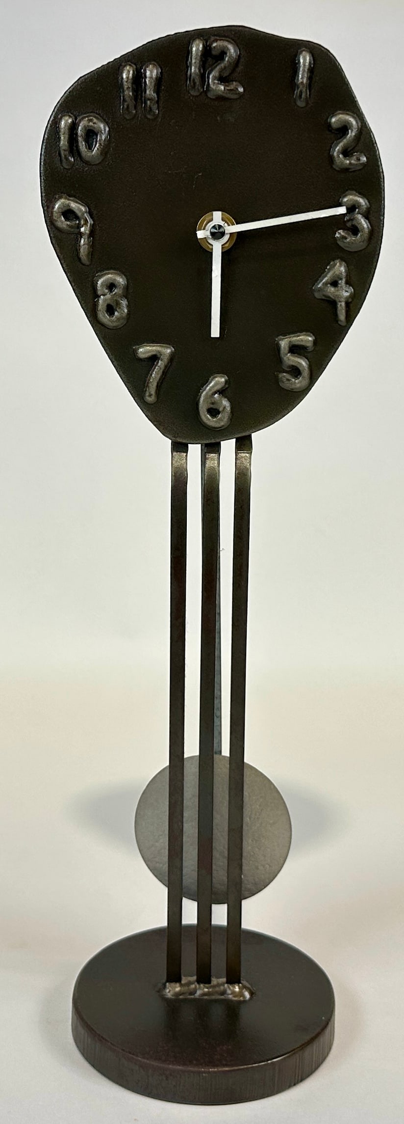 JOHN SARRIUGARTE - FORM AND REFORM CLOCK: METAL ART CLOCK, SIGNED AND TITLED, FORM AND REFORM. BATTERYY OPERATED WORKS. 16.5"