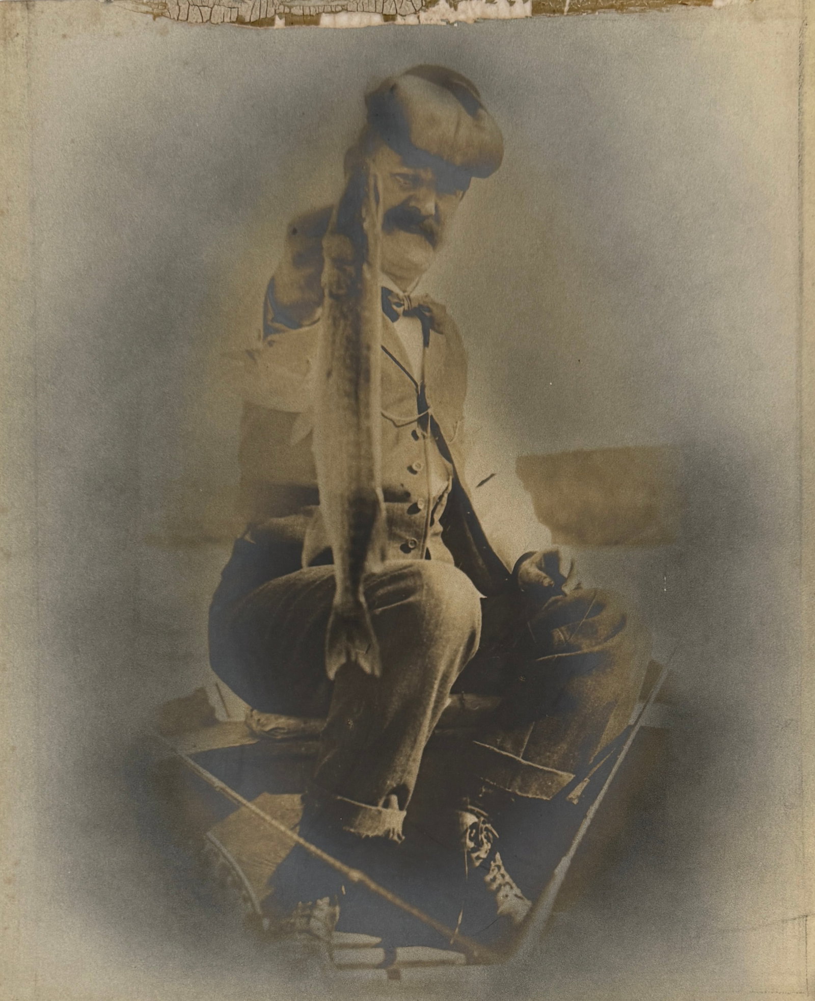 LARGE ANTIQUE PHOTOGRAPH OF A FISHERMAN: OLD PHOTOGRAPH MOUNTED ON BOARD OF A MAN WITH HIS CATCH. 14"X17"