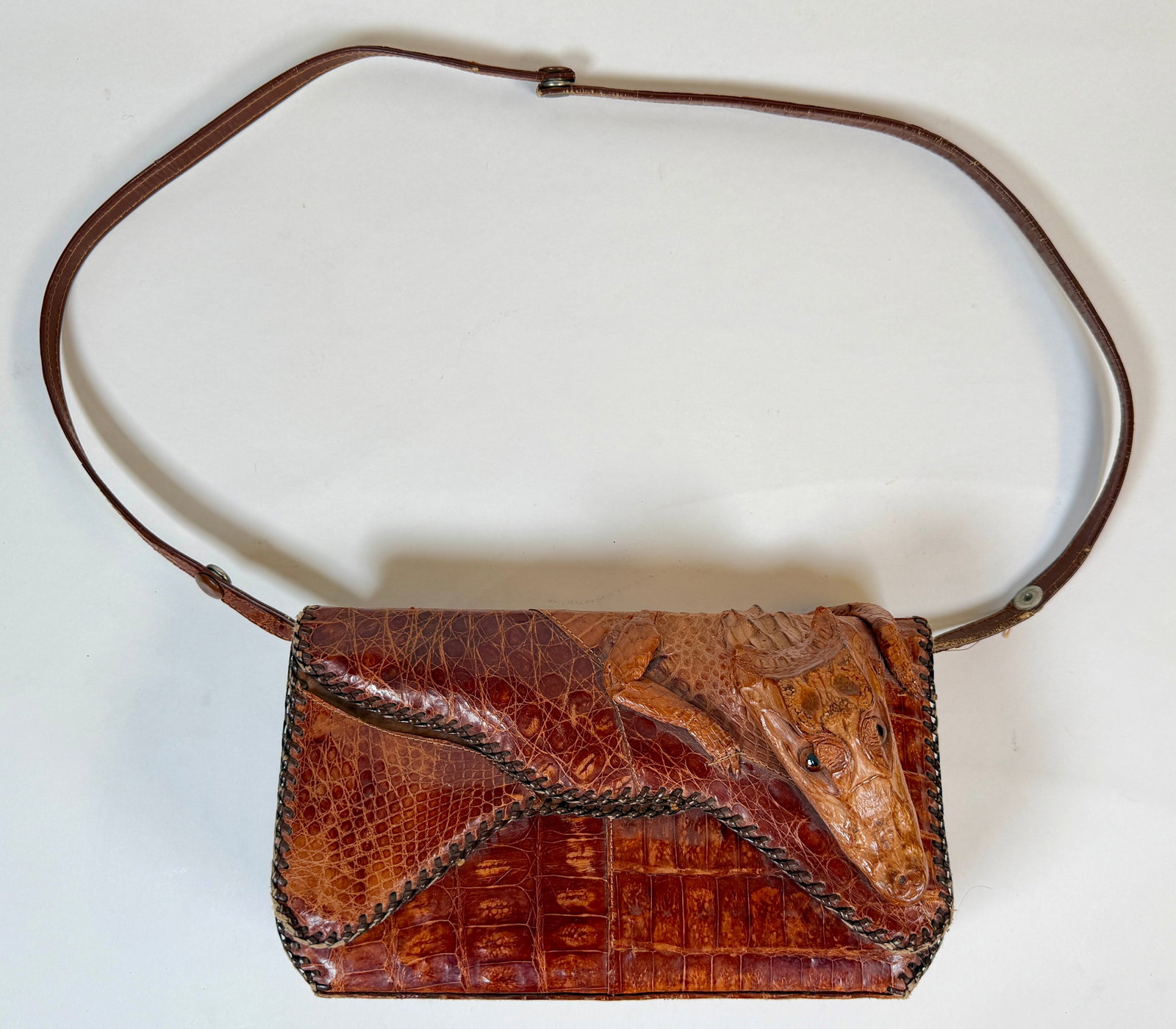 VINTAGE TAXIDERMY ALLIGATOR HANDBAG: SOME WEAR, WRITING ON INTERIOR. WEAR WITH STRAP OR AS A CLUTCH. 10.75"X6"X3".