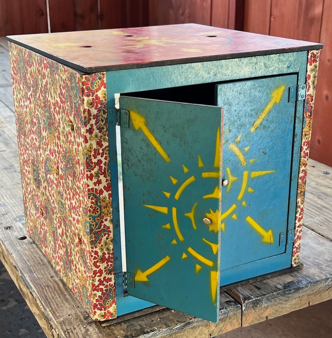 SIDE SHOW MAGICIAN?S VANISHING HEAD PROP: A magician places the box over his assistant?s head, closes the doors, and proceeds to put wooden pins or spikes through pre-drilled holes, when the doors are again opened, all that can be seen are